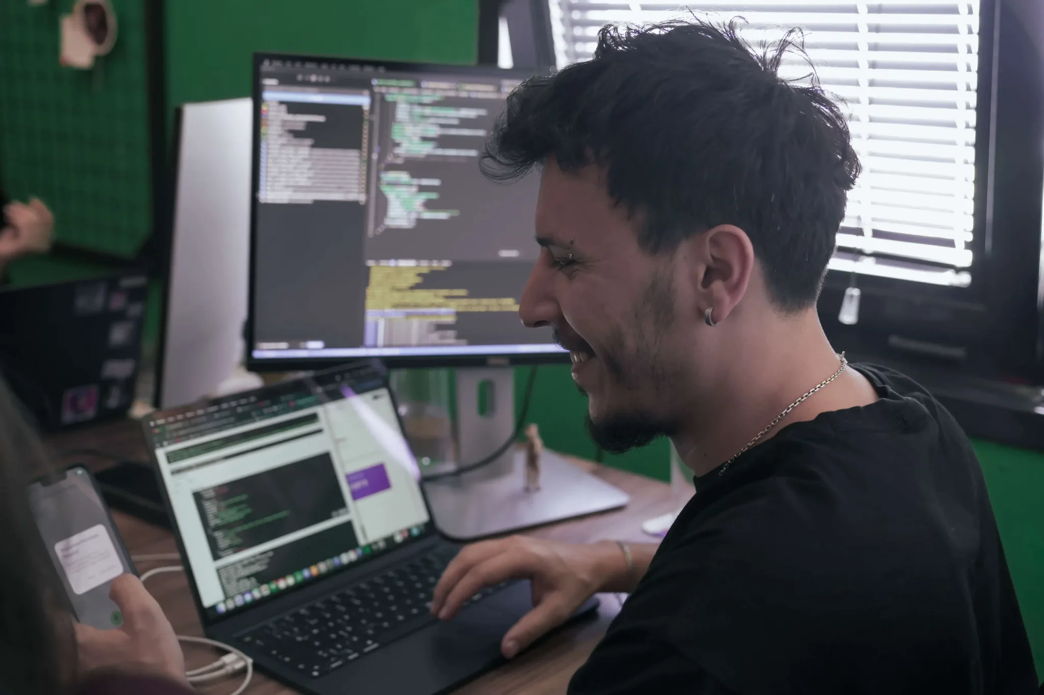 Developer working on mobile app code at Neon Apps office